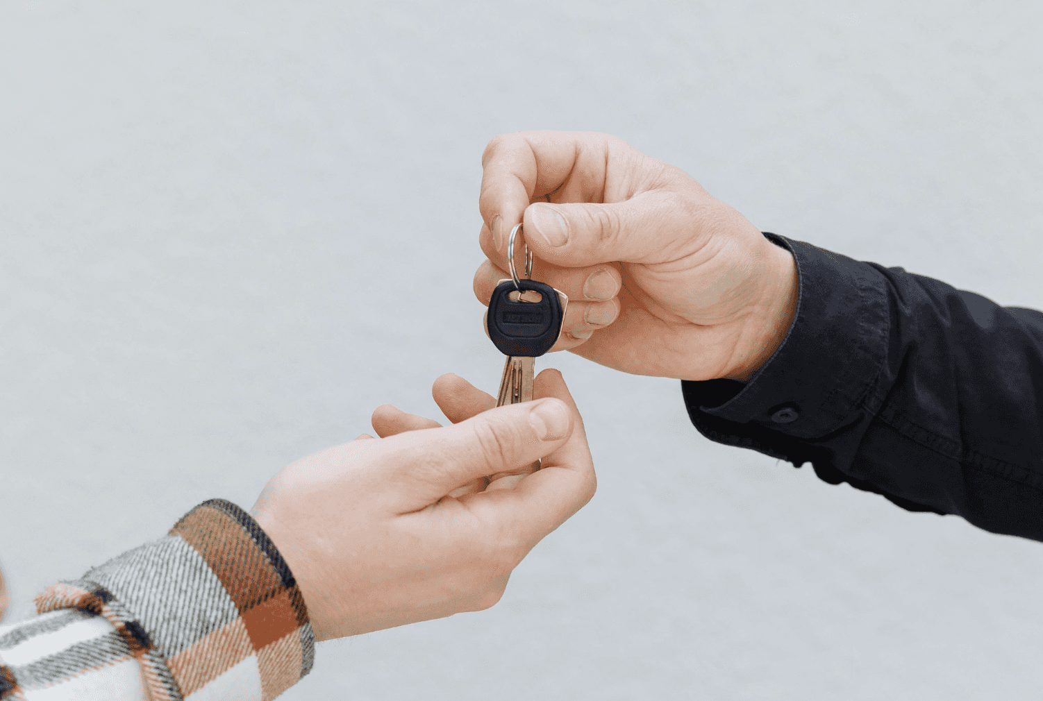 Pair of hands exchanging keys