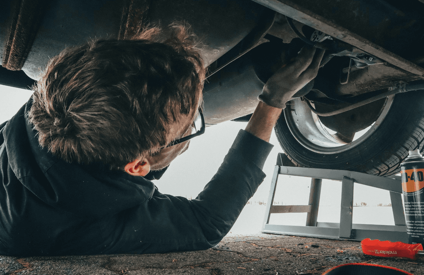 Dodge technician servicing under a vehicle