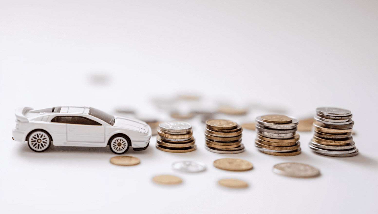 Toy car and money symbolizing the best trade-in value for a car in Buffalo, NY