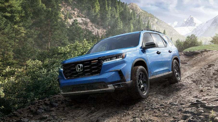2025/2026 Honda Pilot driving on a rugged trail showing off road capability