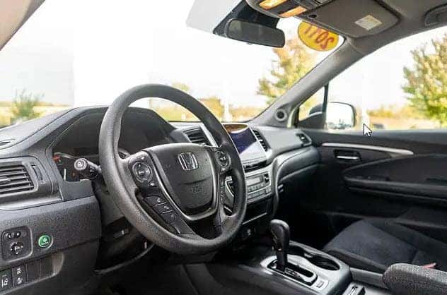 interior view of used Honda Pilot showing dashboard and front seats in Racine Wisconsin