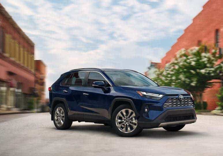Toyota RAV4 driving in city setting with modern exterior design